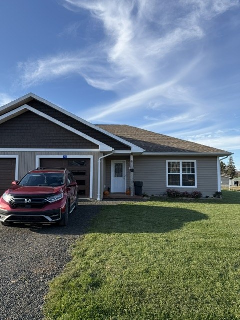 Condo driveway and front entrance with paved lane