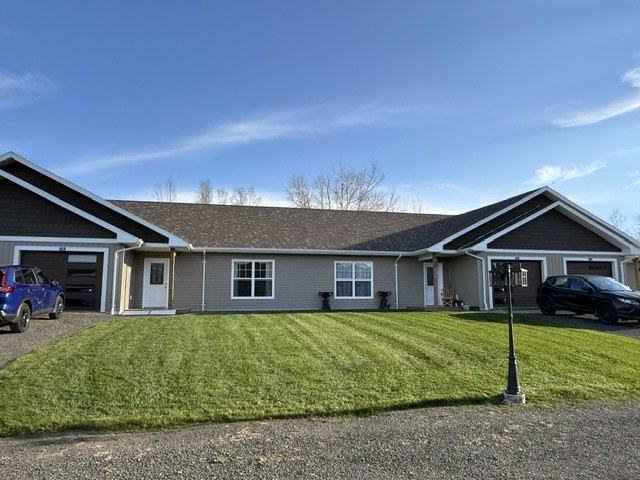 Front view of the Condos at Mountain Gap with attached garages and a green lawn