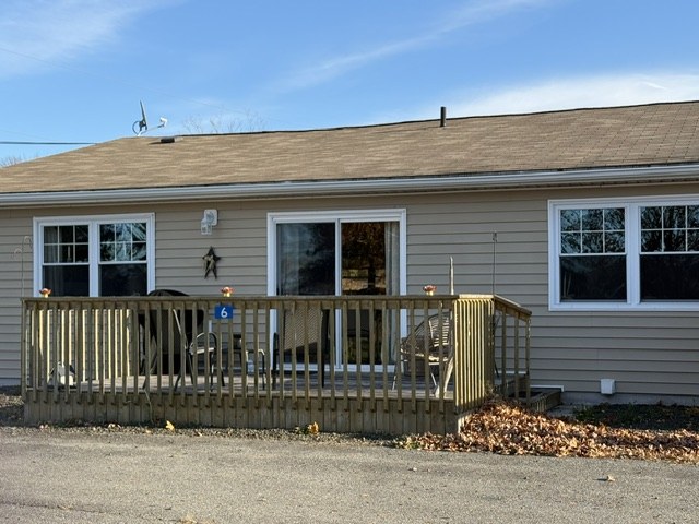 Private wooden deck with patio doors at the back of a condo