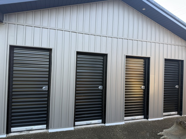 Storage building front with walk-in doors